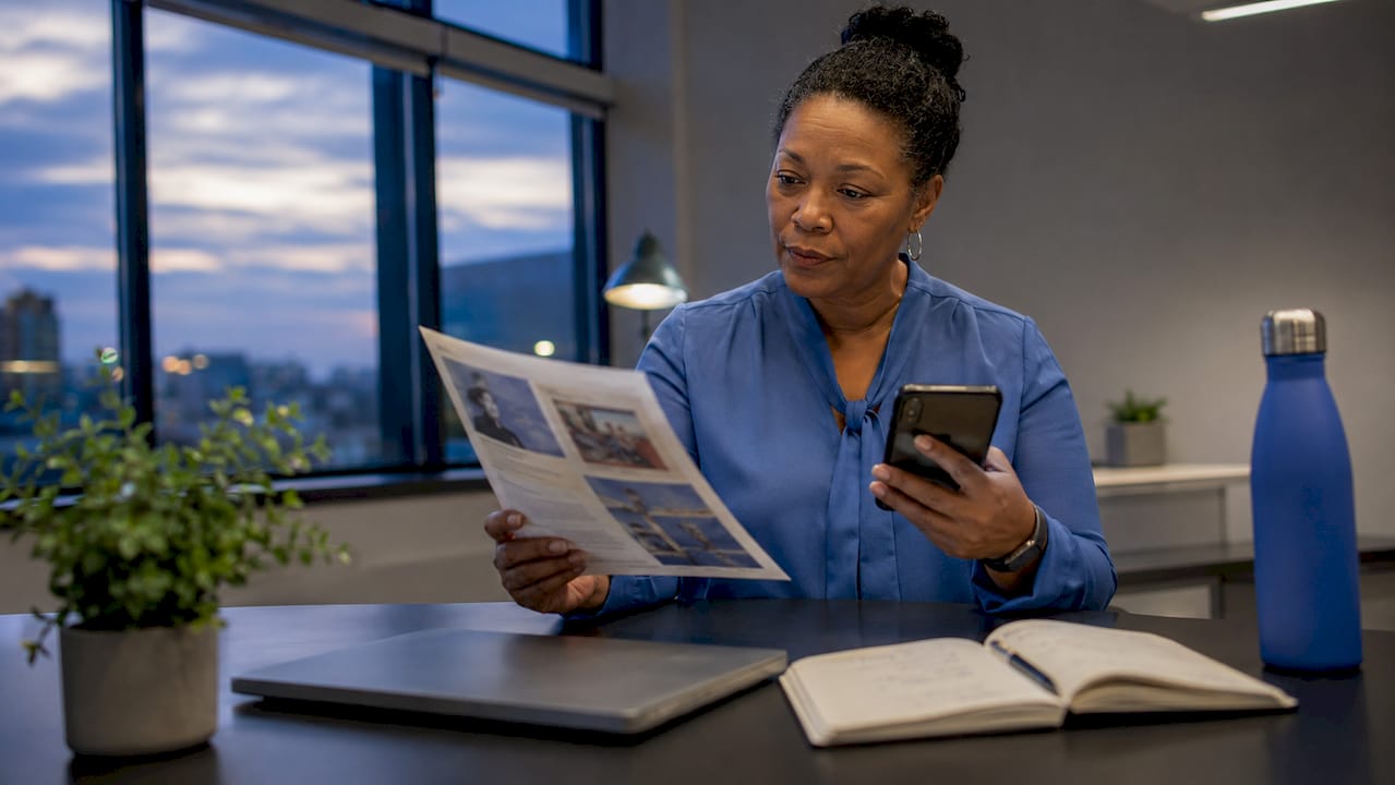 School administrator managing communication tasks at desk