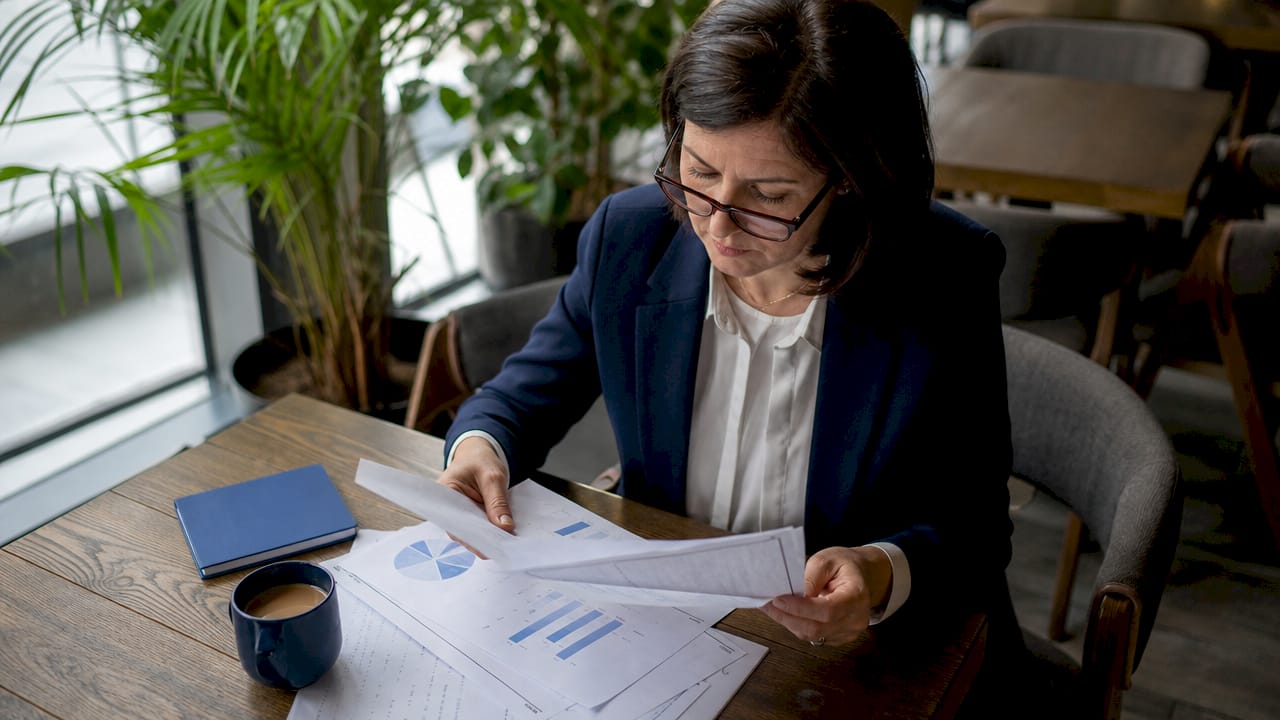 School principal reviewing efficiency reports